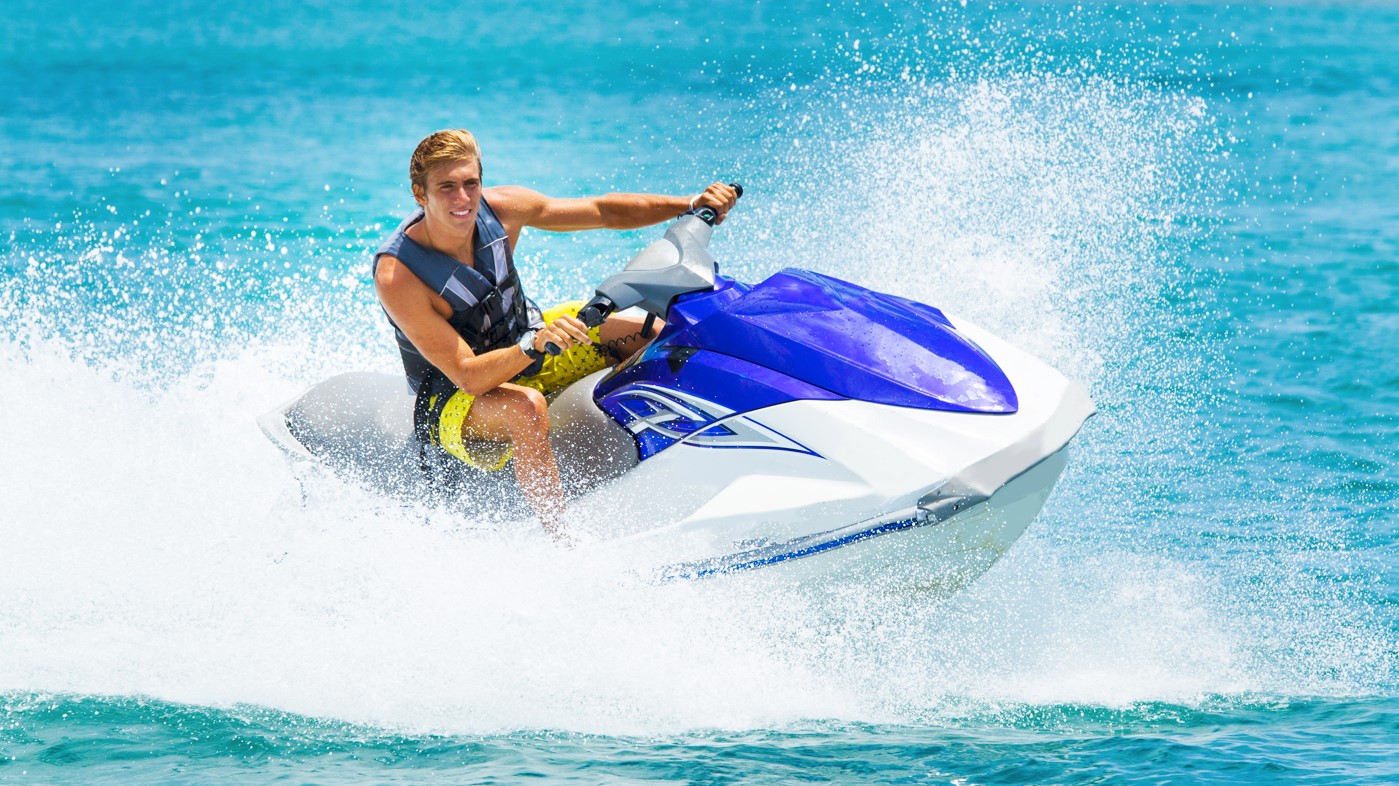 A person driving a jet ski on the sea