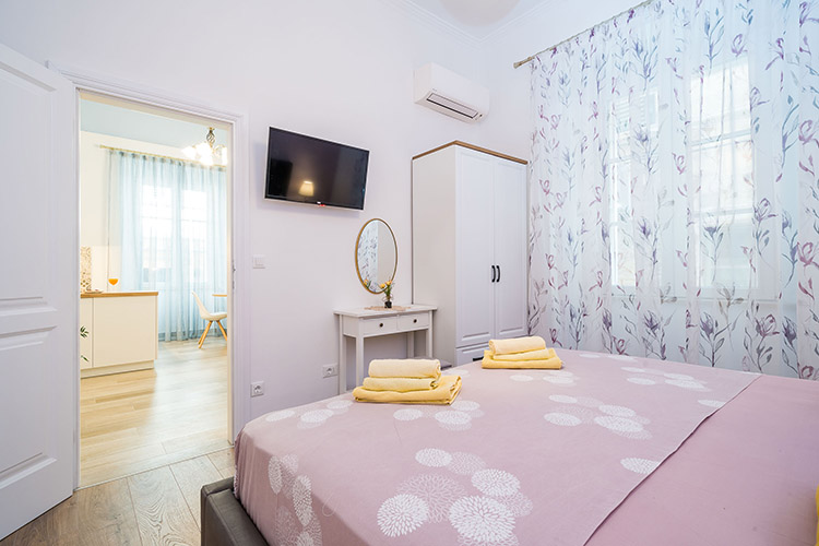 Bedroom towards the entrance with TV and wardrobe